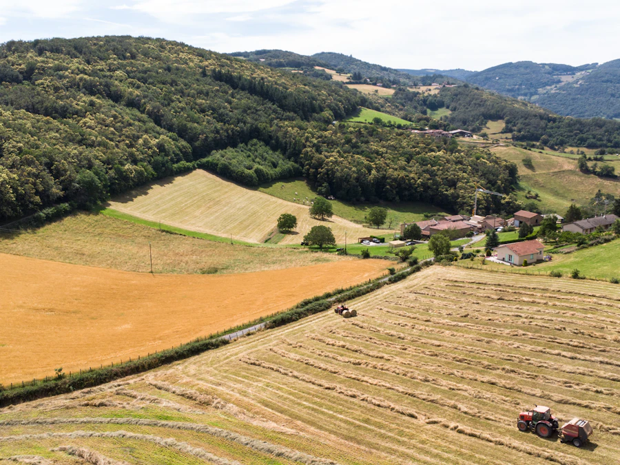 Aerial view of a farm field with a tractor working the land